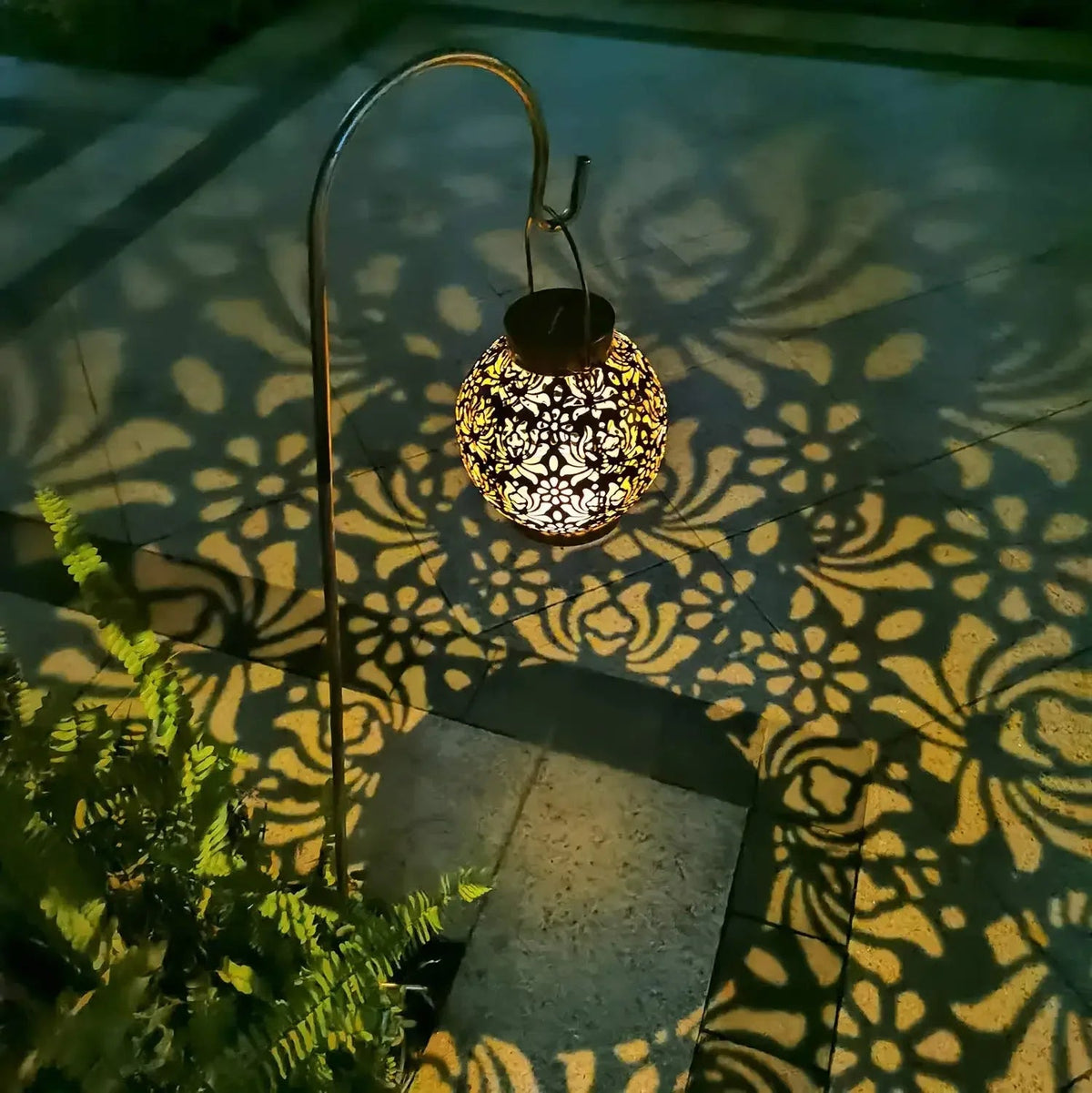 luminária solar de ferro vazado acesa no jardim - foto 6