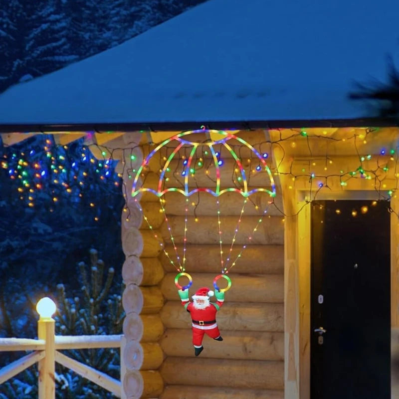 papai noel de paraquedas luminoso em led aceso na varanda - foto 4
