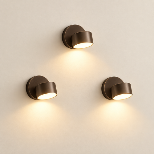 arandela magnética led trio dourada acesa na parede
